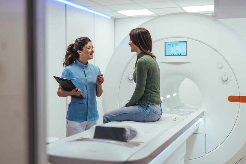 Healthcare Worker Discussing MRI Procedure with Patient in Medical Imaging Room